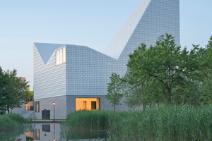  <div class="bildtext_en"><span class="bildnummer">» </span>Mediated between earth and sky: the Blessed Father Rupert Mayer Church Centre in Poing near Munich. meck architects clad the upper, sky-facing part of the building with curved ceramic tiles that act as light reflectors. The building was nominated for the Brick Award in the Building outside the box category in 2020.</div> 