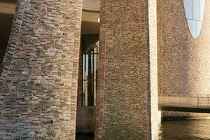  From afar, the building’s surface seems orderly, but upon closer inspection, the different shapes and slightly irregular staggering of the bricks’ depth reveals a lively, organic surface.  