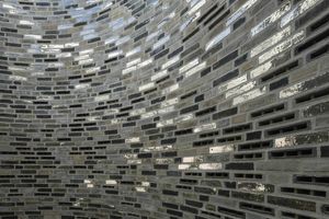  Scattered silver bricks reflect the sunlight shining in from above in the stairwell  