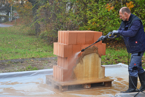  » Hosing down the clay plaster with water 