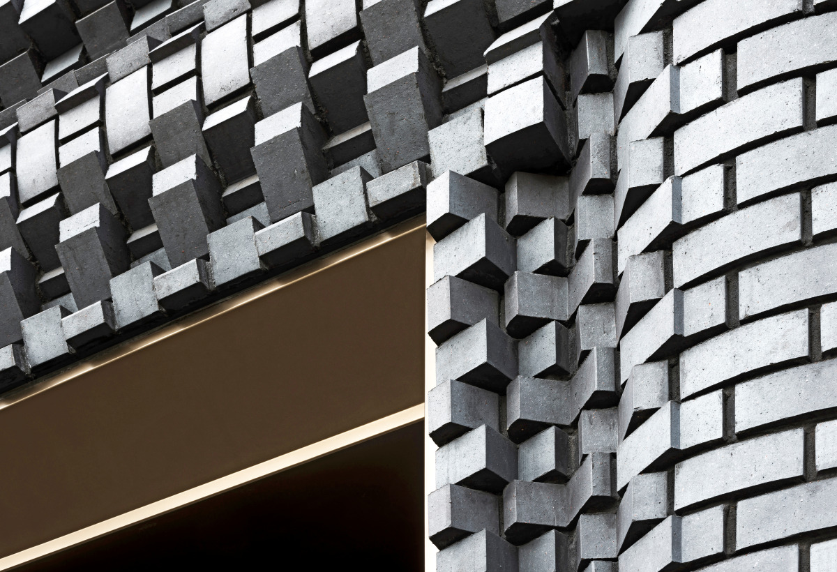 Façade with brick cogwheels - The Interlock by Bureau de