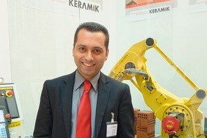  »1 Omer Tuncay, Sales Manager at Keramik Makina San. Tic. Ve Taah. Ltd. Sti., Turkey, pictured in front of an unloading robot 