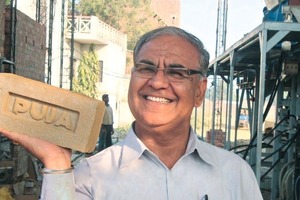  »6 Om Brakash Badlani, managing director of Praya Clay Products in Varanasi, showing off a brick made with an Ishtika mixer press 