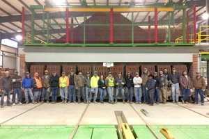  »4 „First Brick out“ in January 2016 – as the team looks on with pride while the first bricks emerge from the kiln  